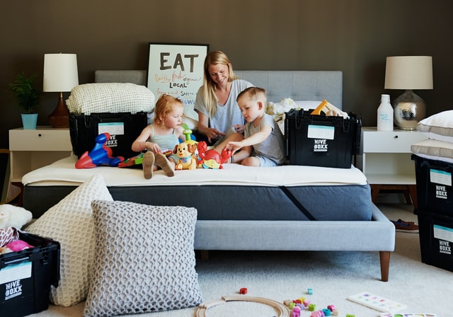 Family surrounded by toys and storage boxes